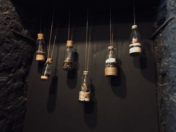 Close-up of light bulb hanging against wall