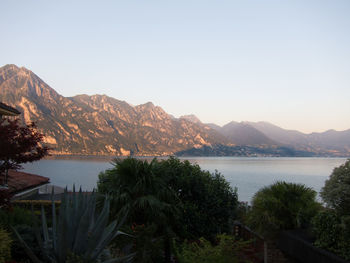 Scenic view of lake and mountains against clear sky