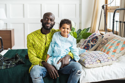 Portrait of father and daughter at home