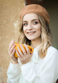 Portrait of smiling young woman holding ice cream