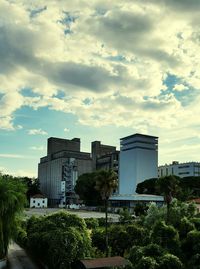 Buildings against cloudy sky