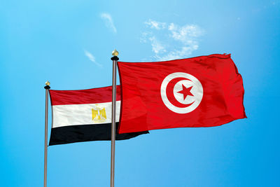 Flags against blue sky