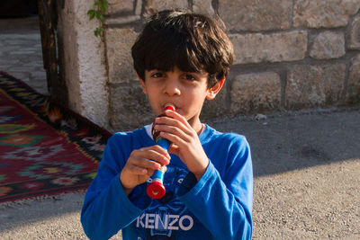 Portrait of boy drinking outdoors