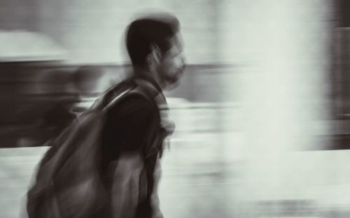 Side view of woman standing against blurred background