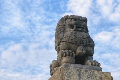 Low angle view of statue against sky