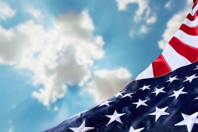 Low angle view of flag against blue sky