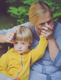 Senior woman holding hand of grandson