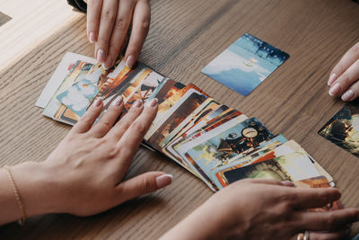 High angle view of woman holding hands on table