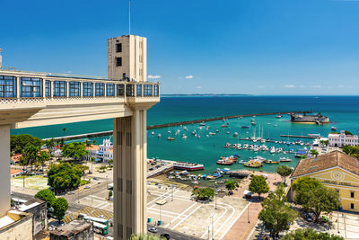 Buildings by sea against sky