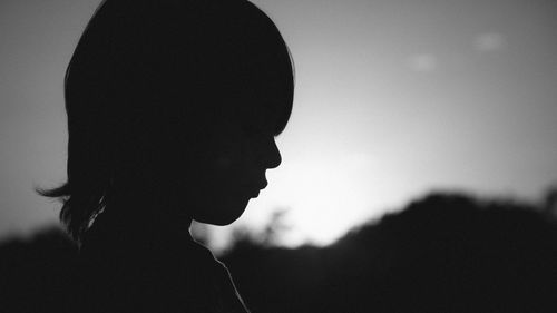 Side view silhouette of sad child