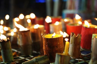 Close-up of lit candles in temple