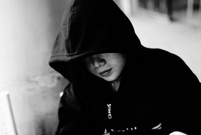 Close-up of mid adult man wearing hooded shirt