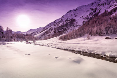 Snow covered landscape against sky