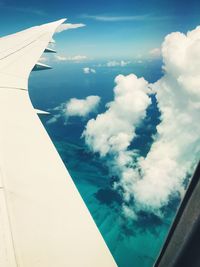 Aerial view of cloudscape over airplane wing