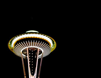 Low angle view of illuminated tower at night