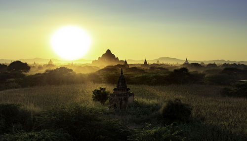 Silhouette of temple against sky during sunset