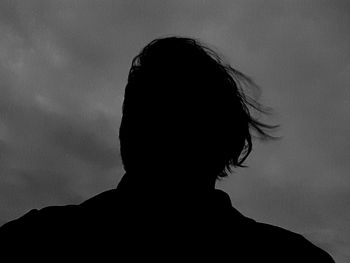 Silhouette of woman against sky