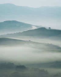 Misty landscape at sunrise in tuscany