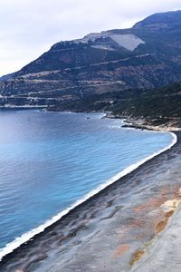 Scenic view of sea and mountains against sky