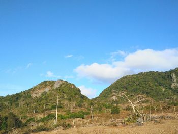 Scenic view of mountains against blue sky