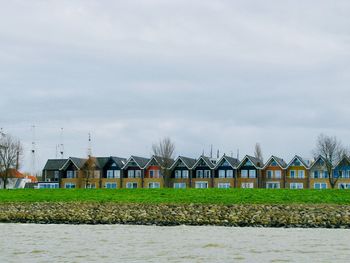 Houses on field against sky