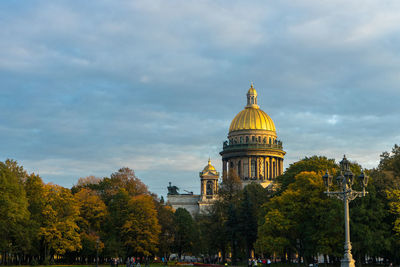 View of trees and isaac's cathedral against sky