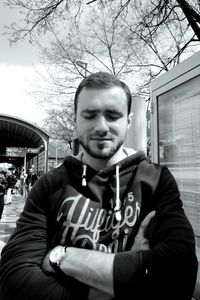 Mid adult man in front of building