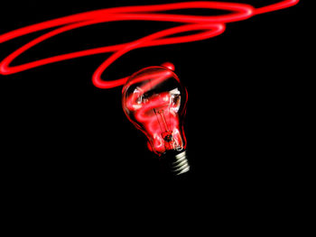 Close-up of light bulb against black background