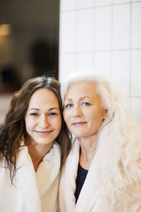 Portrait of mother and daughter relaxing in spa