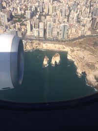 Cropped image of airplane flying over city