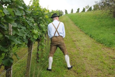 Rear view of man standing by plants