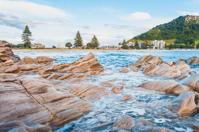 Rocks on shore against sky
