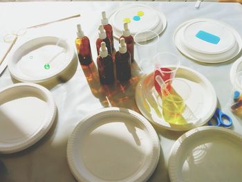 High angle view of plates with bottles on table in laboratory