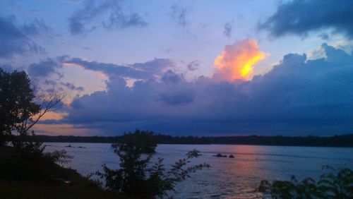 Scenic view of lake against cloudy sky