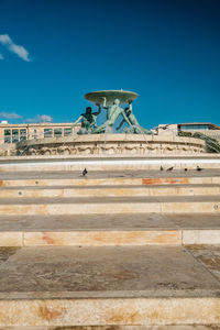 Low angle view of historical building against blue sky