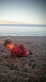 Full length of a girl standing on beach