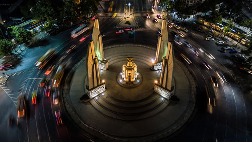 High angle view of light trails amidst trees at night