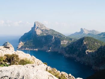 Panoramic view of sea and mountains against sky