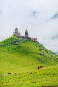 Castle by building against sky