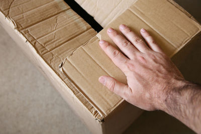 High angle view of person hand in box