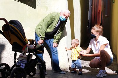 Group of family in the street wearing masks to protect against coronavirus