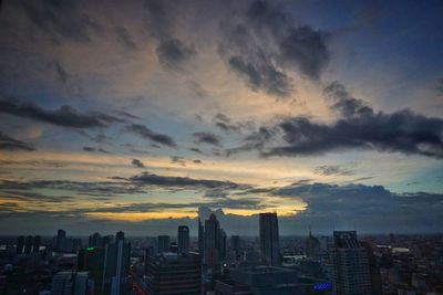 Cityscape against sky at sunset