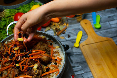 Cropped hands of man preparing food
