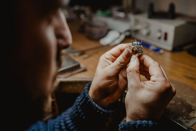 Midsection of man working on table