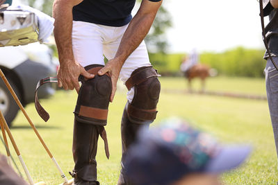 Man wearing knee pad while standing on field