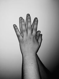 Close-up of human hand against white background