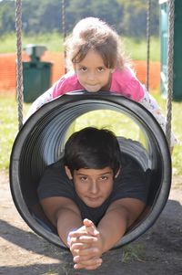 Portrait of siblings playing in playground