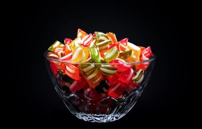 Close-up of multi colored candies against black background