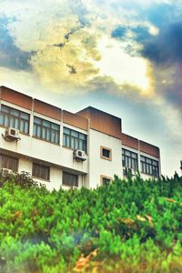 Buildings against cloudy sky