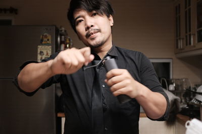 Portrait of young man holding camera